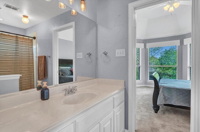 full bathroom with ensuite bathroom, visible vents, vanity, and a ceiling fan