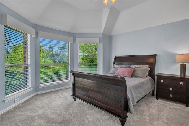 carpeted bedroom with vaulted ceiling, baseboards, and ceiling fan