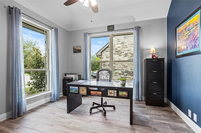 office area featuring baseboards, a ceiling fan, wood finished floors, and a wealth of natural light