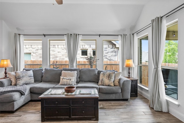 interior space featuring vaulted ceiling, plenty of natural light, light wood-style floors, and a ceiling fan
