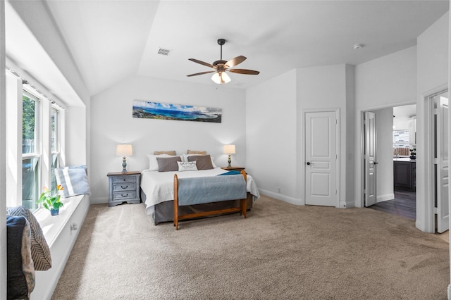 carpeted bedroom featuring vaulted ceiling, visible vents, baseboards, and multiple windows