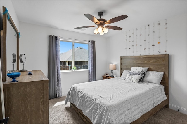 carpeted bedroom featuring ceiling fan and baseboards