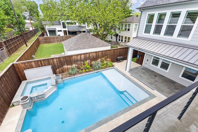 view of pool featuring a fenced backyard, a patio, a pool with connected hot tub, and a lawn