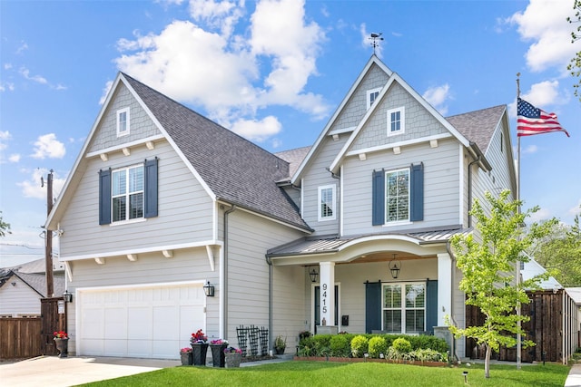view of front of house with an attached garage, fence, driveway, and covered porch