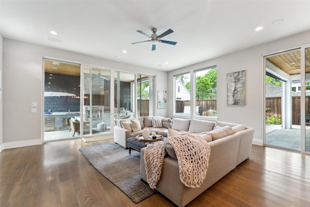 living room featuring baseboards, wood finished floors, recessed lighting, and ceiling fan