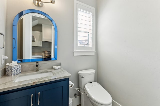 bathroom featuring backsplash, toilet, and vanity