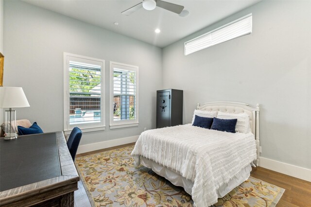 bedroom featuring ceiling fan, baseboards, wood finished floors, and recessed lighting