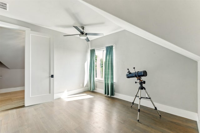 additional living space with baseboards, a ceiling fan, wood finished floors, and visible vents