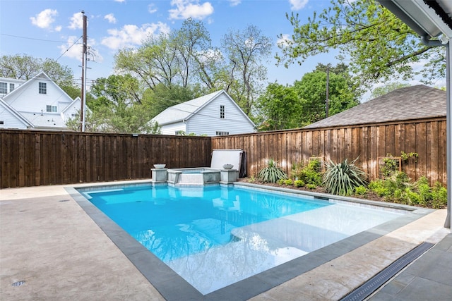 view of pool featuring a fenced backyard and a pool with connected hot tub