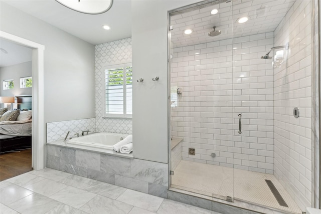 ensuite bathroom with a bath, plenty of natural light, ensuite bath, and a stall shower