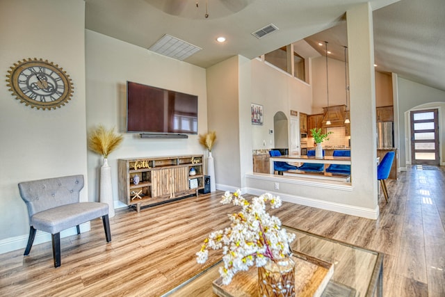 1023 Clydeview Rd, Forney, TX 75126 - living room featuring arched walkways, baseboards, and visible vents