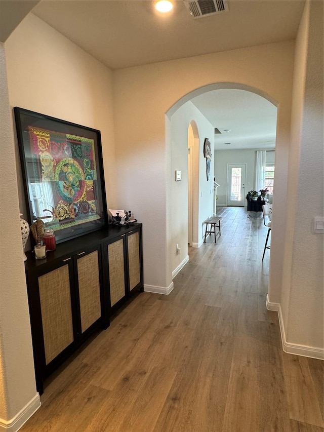 7412 Yearwood Dr, Mckinney, TX 75071 - hall featuring arched walkways, wood finished floors, visible vents, and baseboards