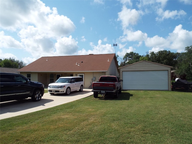 view of front facade featuring a front lawn, an outdoor structure, and a garage