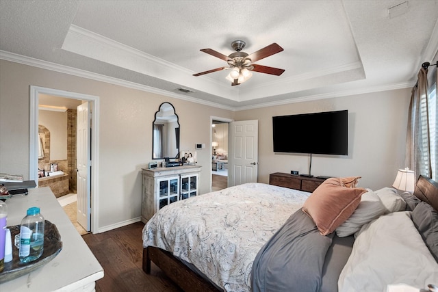 bedroom with a tray ceiling, dark wood-style floors, and ornamental molding