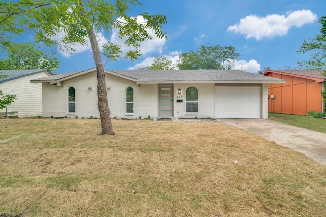 237 Trailridge Dr, Garland, TX 75043 - view of front facade with a garage, concrete driveway, a front yard, and brick siding