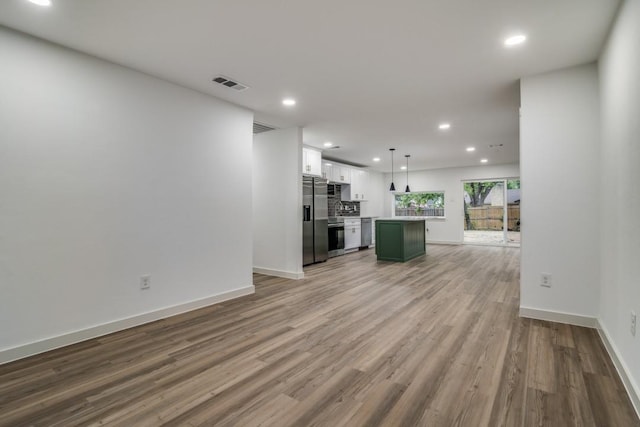 237 Trailridge Dr, Garland, TX 75043 - unfurnished living room featuring recessed lighting, baseboards, visible vents, and wood finished floors