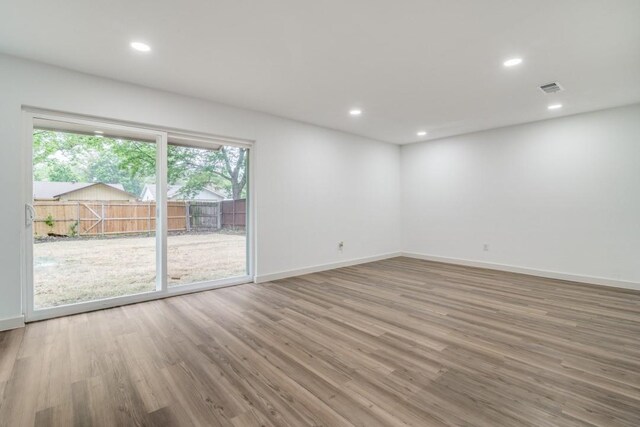 237 Trailridge Dr, Garland, TX 75043 - spare room with plenty of natural light, baseboards, wood finished floors, and visible vents