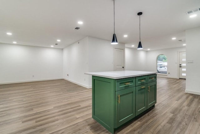 237 Trailridge Dr, Garland, TX 75043 - kitchen featuring baseboards, open floor plan, a center island, light wood finished floors, and green cabinets