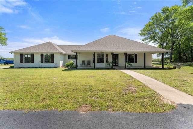 view of front facade featuring a front lawn and covered porch