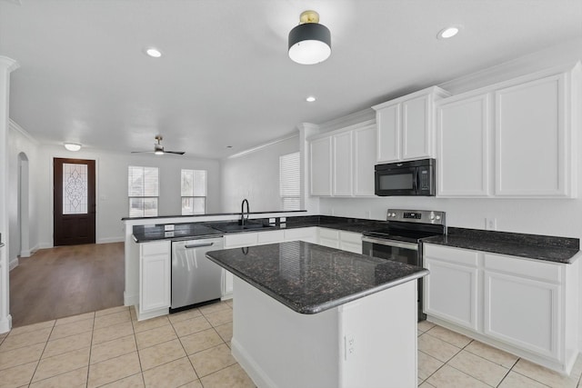 924 Charleston Ln, Savannah, TX 76227 - kitchen featuring white cabinets, a peninsula, light tile patterned floors, and appliances with stainless steel finishes