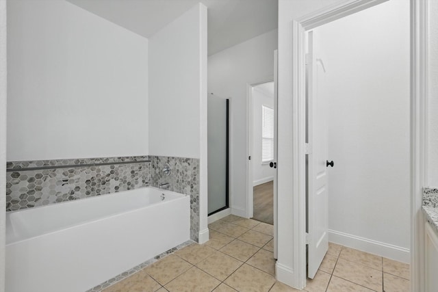 924 Charleston Ln, Savannah, TX 76227 - full bath featuring a garden tub, baseboards, tile patterned flooring, and a stall shower