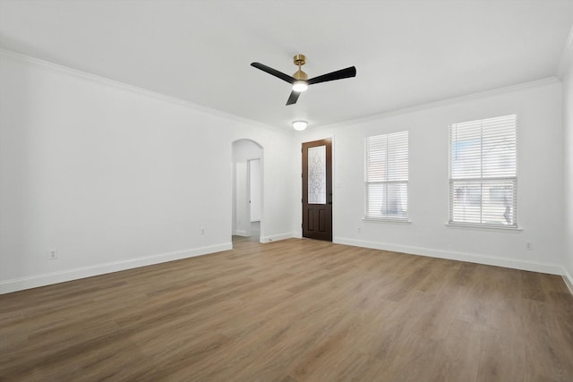 924 Charleston Ln, Savannah, TX 76227 - unfurnished room featuring a ceiling fan, wood finished floors, arched walkways, baseboards, and ornamental molding