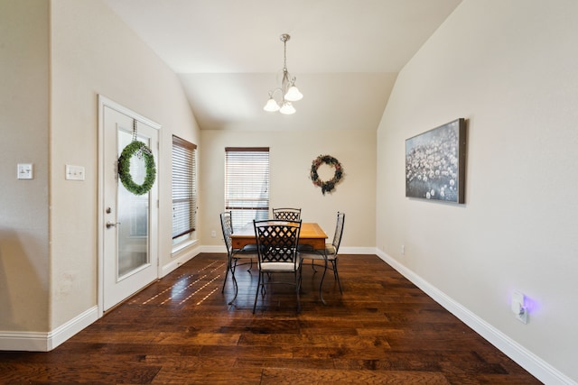 dining area featuring vaulted ceiling, baseboards, dark wood-style flooring, and an inviting chandelier