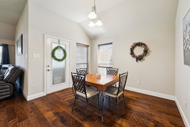 dining space featuring baseboards, lofted ceiling, dark wood-type flooring, and an inviting chandelier