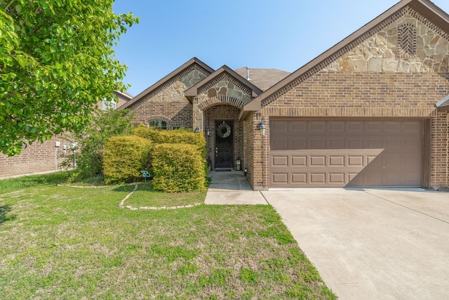 french country inspired facade featuring an attached garage, driveway, brick siding, and a front yard