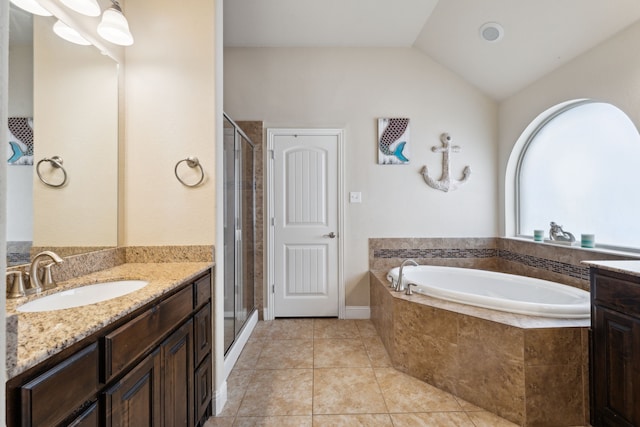 full bath with a garden tub, vaulted ceiling, a stall shower, vanity, and tile patterned flooring
