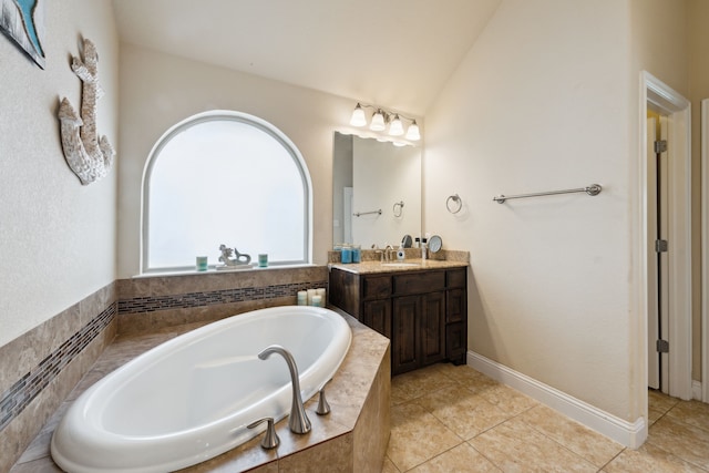 bathroom with a bath, vanity, tile patterned flooring, and lofted ceiling