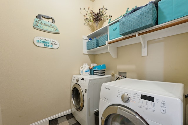 laundry room with separate washer and dryer, baseboards, and laundry area