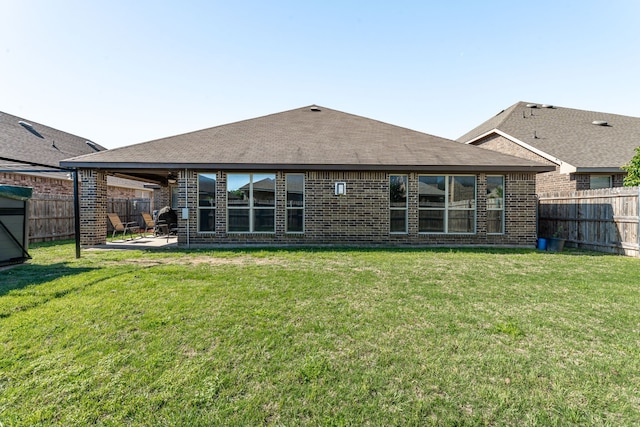 back of property featuring a fenced backyard and brick siding