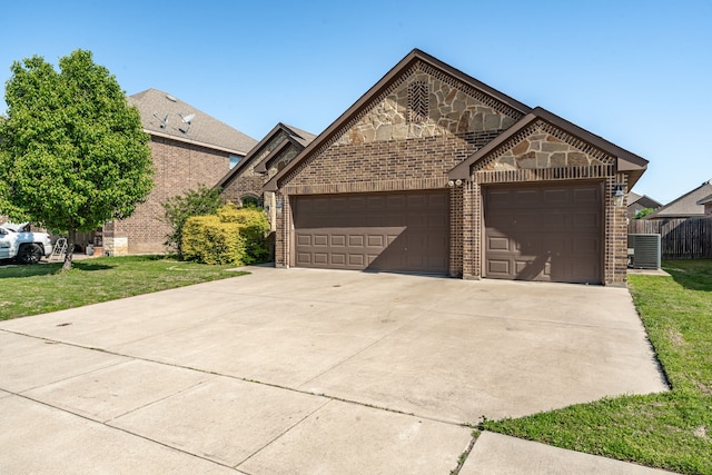 french country style house with brick siding, an attached garage, a front yard, and concrete driveway