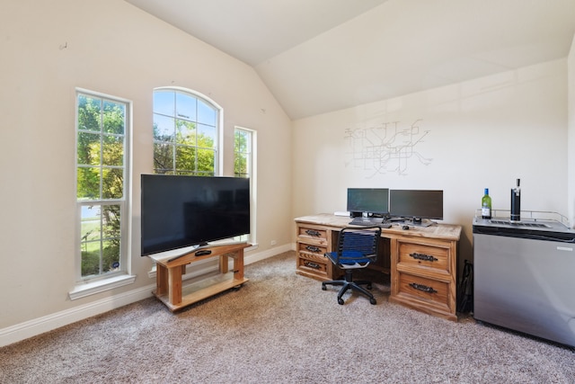 carpeted home office featuring lofted ceiling and baseboards