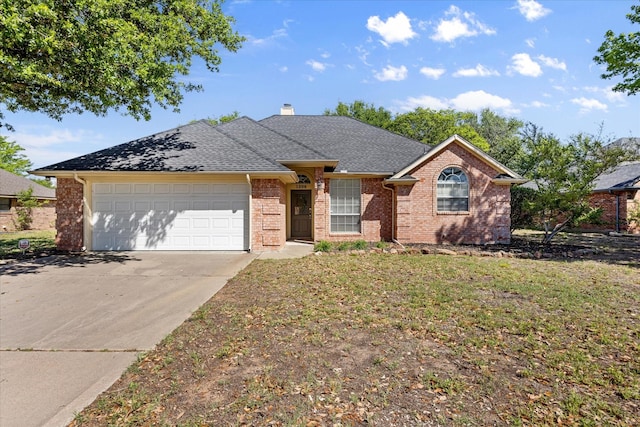 single story home featuring roof with shingles, a chimney, brick siding, concrete driveway, and an attached garage