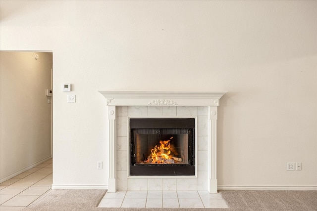 room details featuring baseboards and a tile fireplace