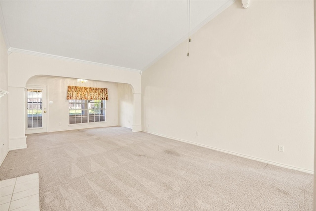 empty room with arched walkways, baseboards, lofted ceiling, ornamental molding, and light carpet