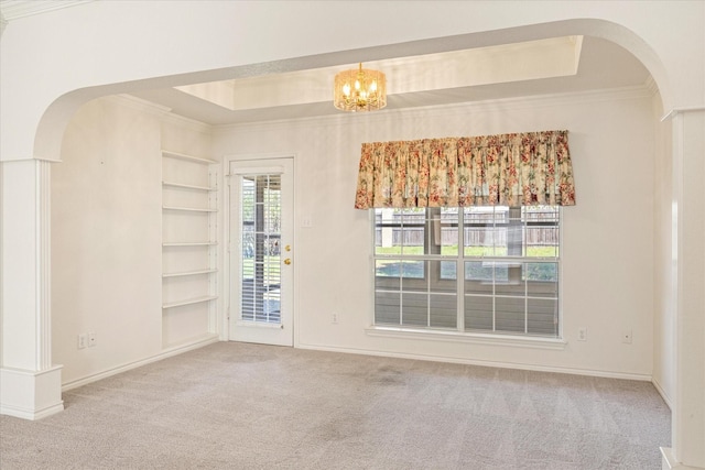 unfurnished room with arched walkways, ornamental molding, and carpet