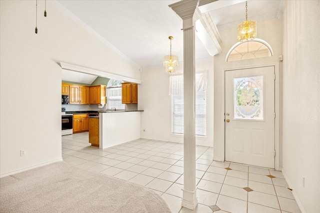 foyer entrance featuring a healthy amount of sunlight, lofted ceiling, and a chandelier