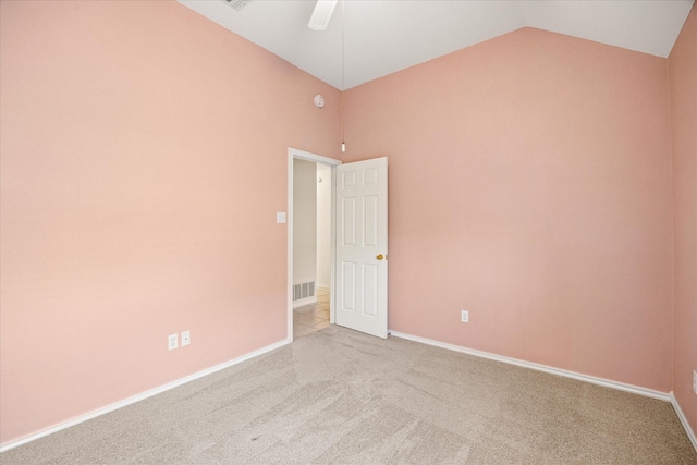 empty room with a ceiling fan, visible vents, carpet floors, baseboards, and lofted ceiling