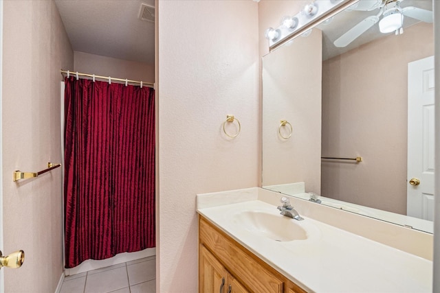 full bathroom featuring ceiling fan, visible vents, tile patterned flooring, curtained shower, and vanity