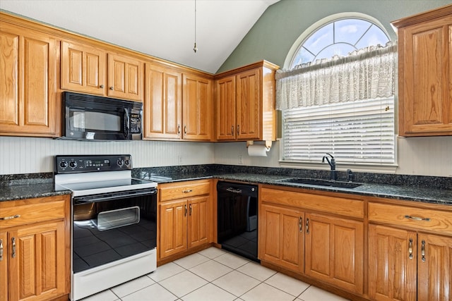 kitchen with a sink, light tile patterned floors, black appliances, lofted ceiling, and dark stone counters
