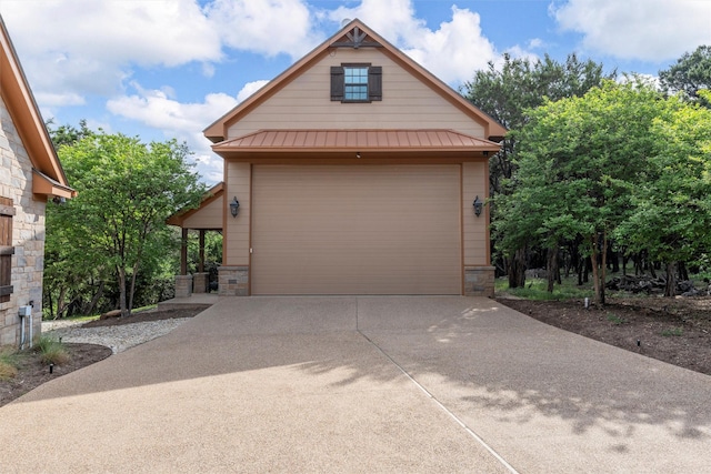 garage featuring concrete driveway