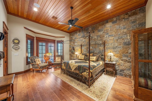 bedroom featuring wood ceiling, wood-type flooring, visible vents, and crown molding