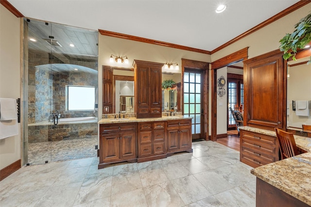 full bathroom with a bath, a sink, double vanity, and a stall shower