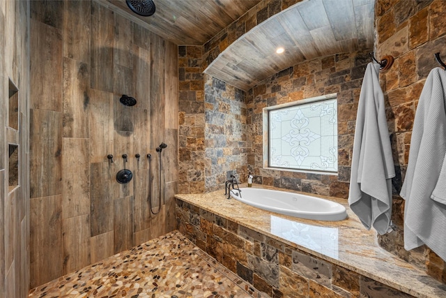 full bathroom with a bath, vaulted ceiling, and a tile shower