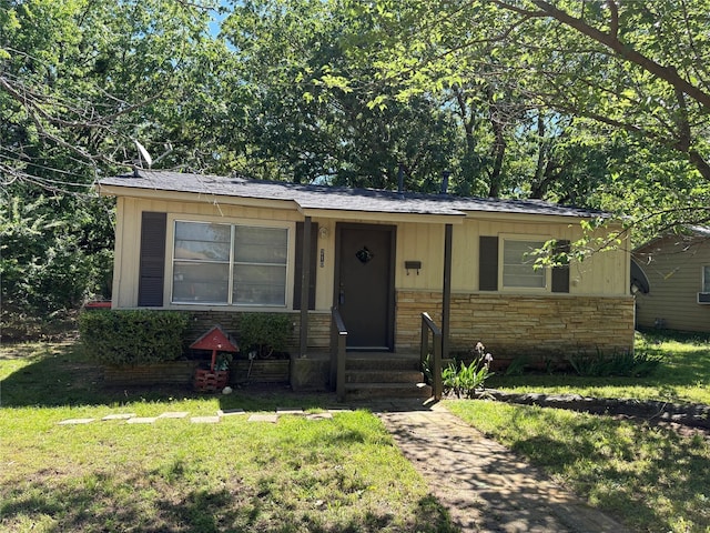 view of front of property with stone siding and a front yard