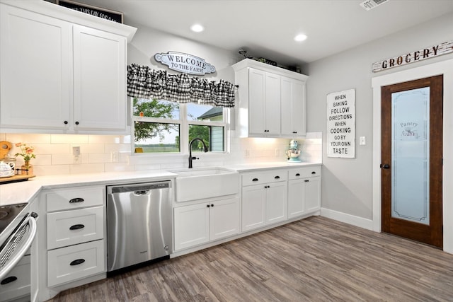 kitchen featuring backsplash, light wood-type flooring, a sink, white cabinets, and stainless steel appliances