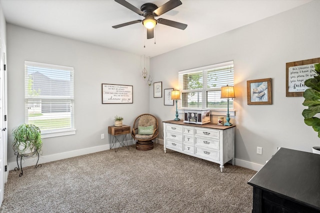 sitting room with carpet floors, baseboards, and ceiling fan